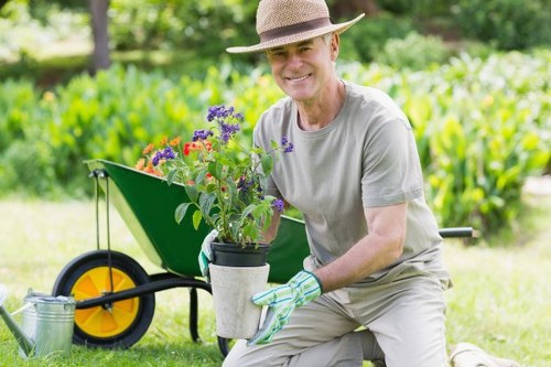Supervisor reviewing work and taking notes at a garden site